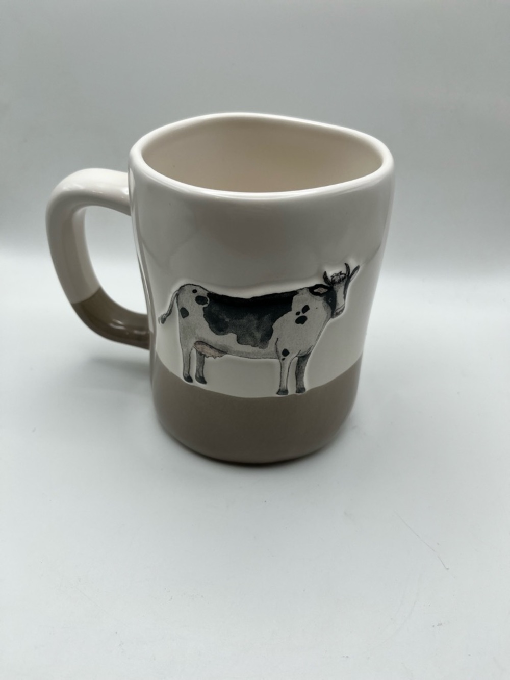 Rae Dunn Ceramic Cow Accent Mug in Beige and White